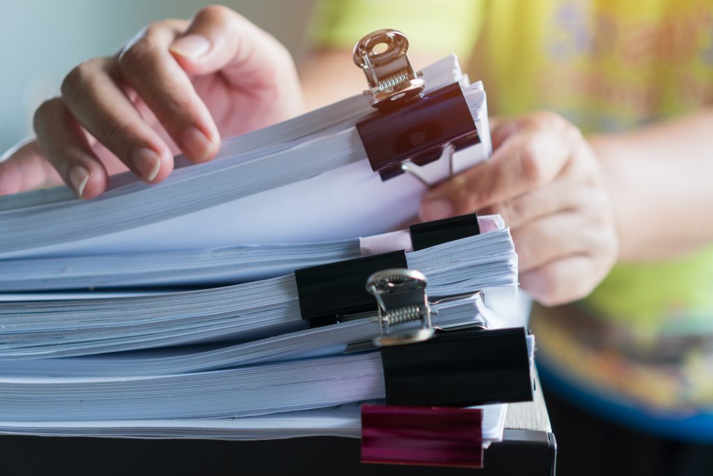 Stacks documents of paper files, Businessman hands working in me
